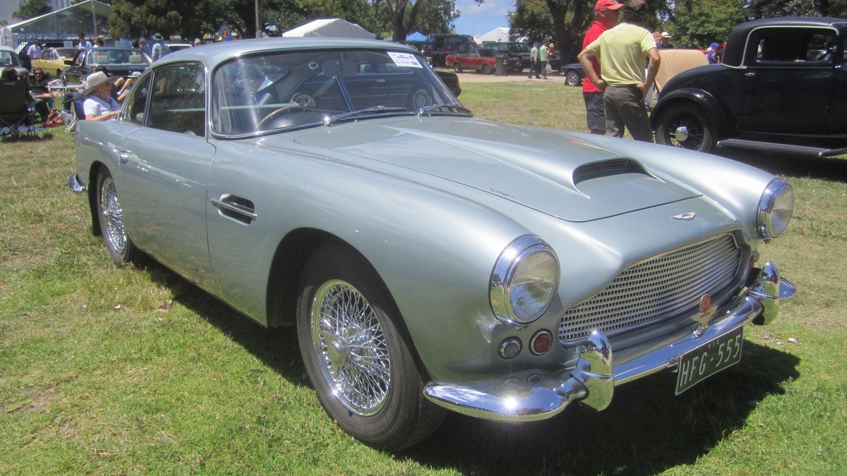 Aston Martin sports car displayed in an executive showroom setting