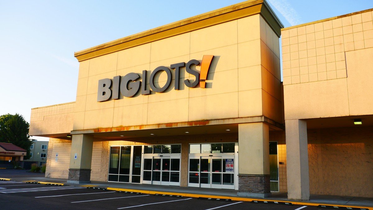 Exterior storefront of a suburban Big Lots discount home goods retail store displaying promotional banners