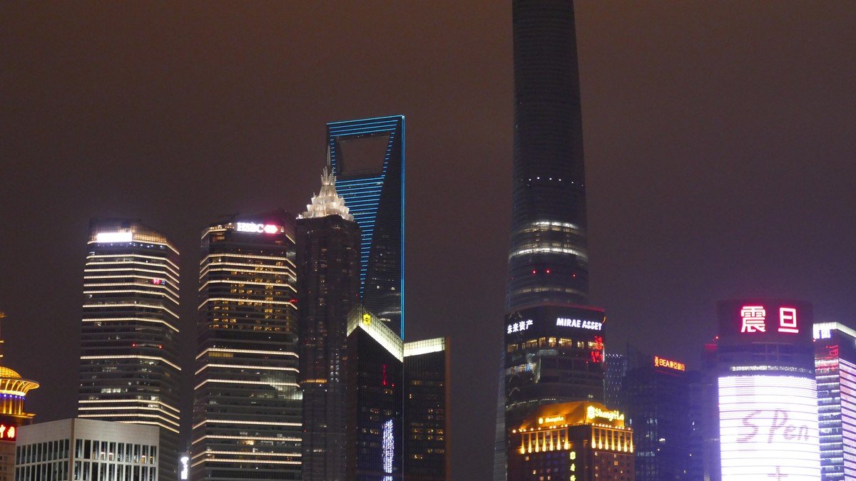 Shanghai Stock Exchange building and financial district skyscrapers illuminated at dusk