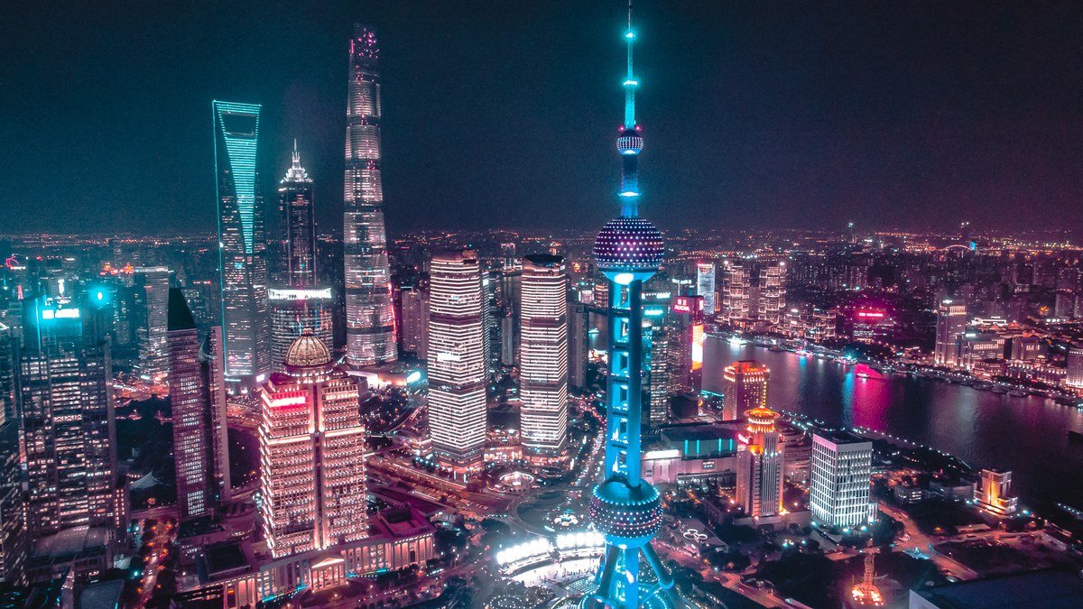 Electronic stock market ticker screens at the Shanghai Stock Exchange showing surging green and red index numbers