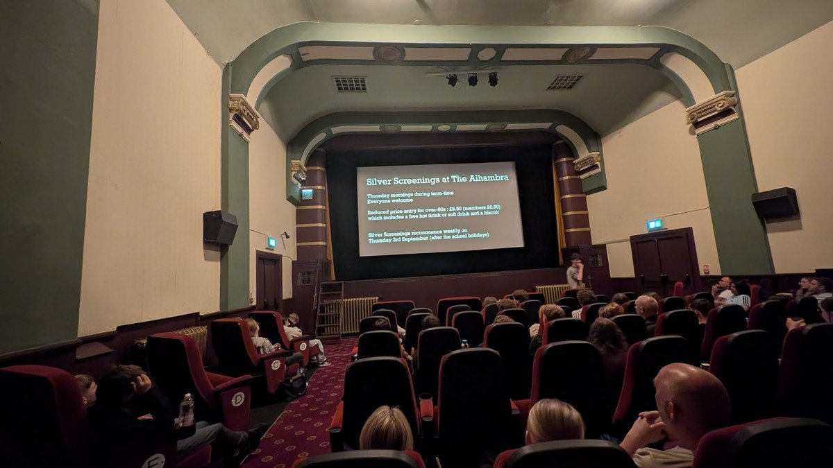 Auditorium stage with illuminated theatrical entertainment screens and vibrant digital projections