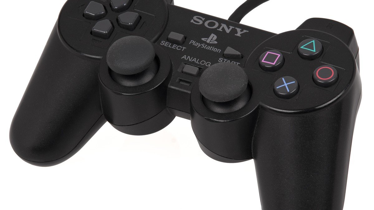 Retail store shelves displaying copies of EA Sports FC 25 alongside gaming controllers