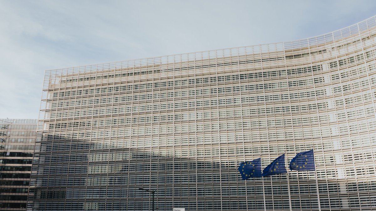 Lush tropical rainforest canopy bordering agricultural land under European environmental regulation scrutiny