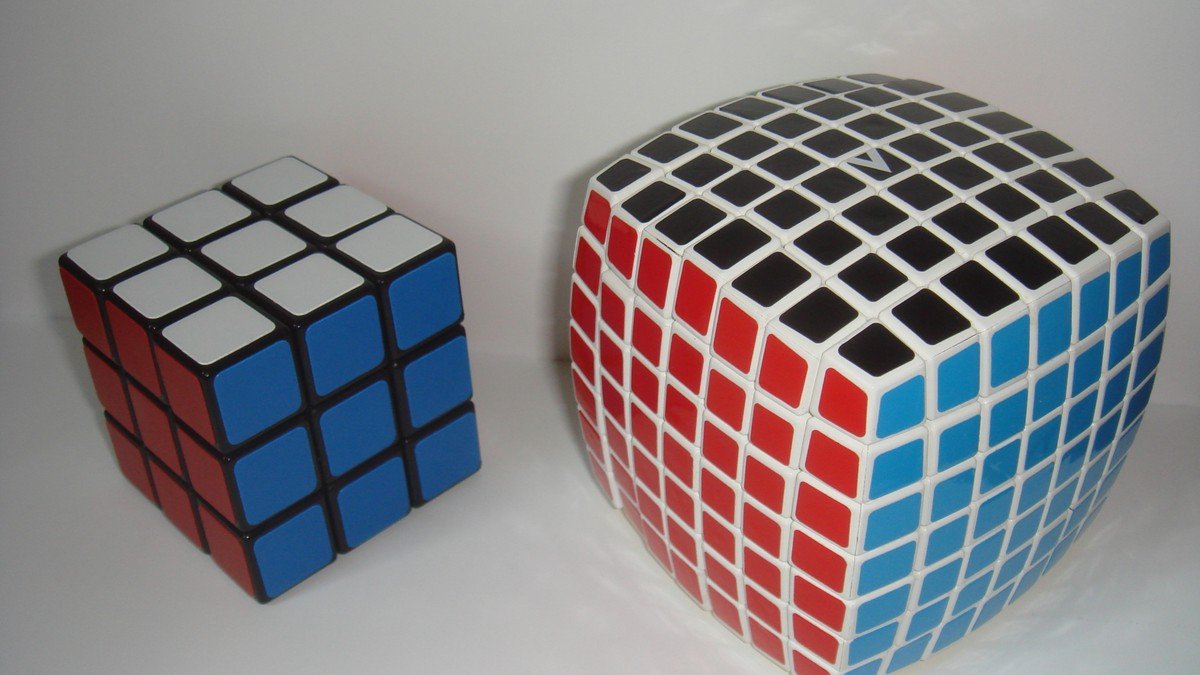Close-up of hands holding a colorful 3x3 Rubik's cube with motion blur during speedcubing