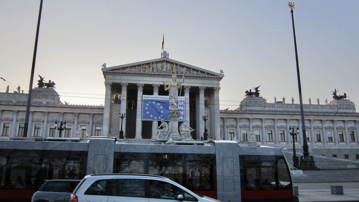 Austrian Parliament building in Vienna illuminated at dusk during the national election count