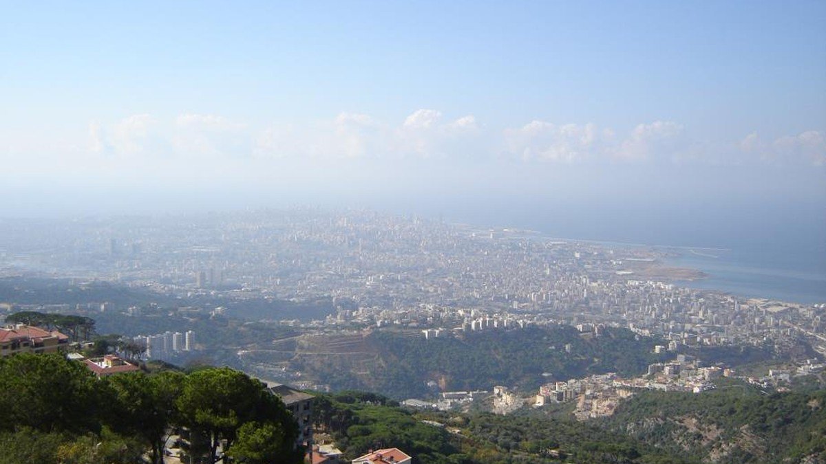 Beirut southern suburbs skyline showing urban destruction and smoke following military strikes