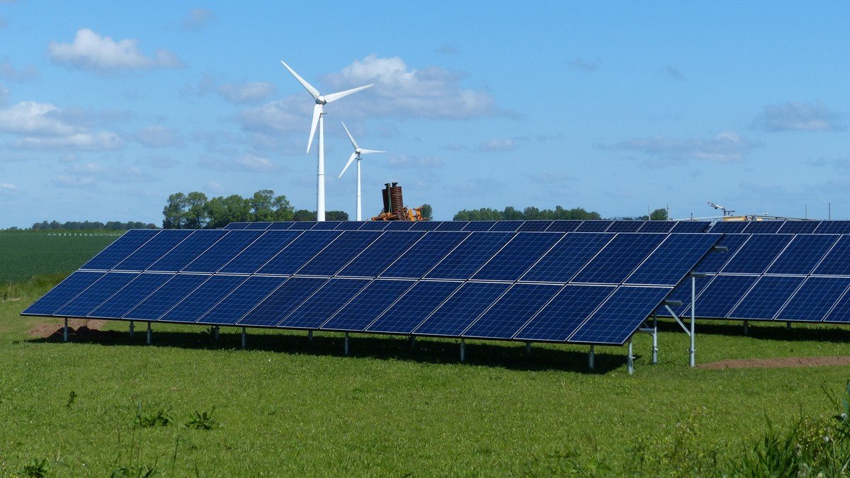 Clean energy technicians installing high-efficiency solar photovoltaic panels on a commercial rooftop