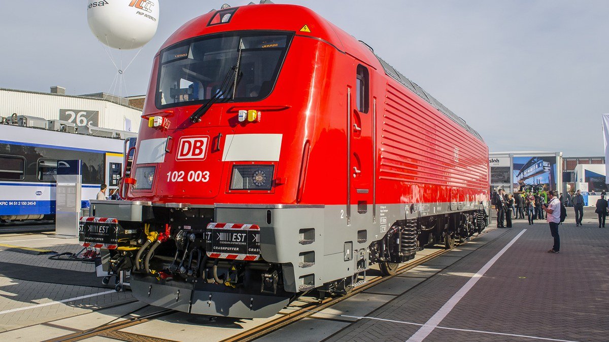 Sleek aerodynamic zero-emission hydrogen passenger train parked on outdoor exhibition tracks at InnoTrans Berlin