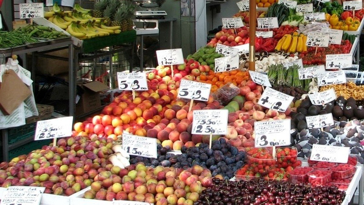 Fresh organic fruits, colorful vegetables, and whole grains arranged on a rustic wooden table