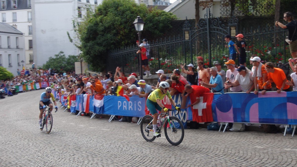 Belgian cyclist Lotte Kopecky celebrating in the Rainbow Jersey at the finish line of the UCI Road World Championships in Zurich