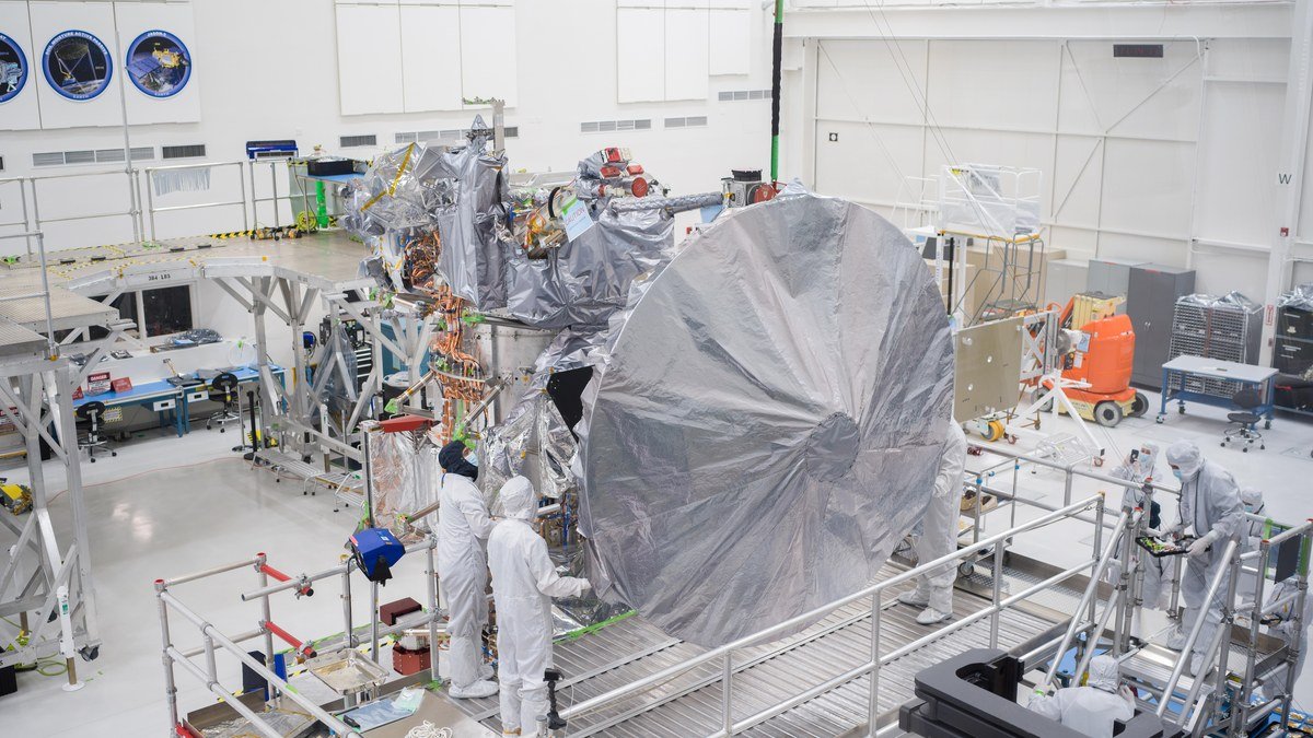 NASA Europa Clipper spacecraft in clean room facility with massive solar arrays and instruments