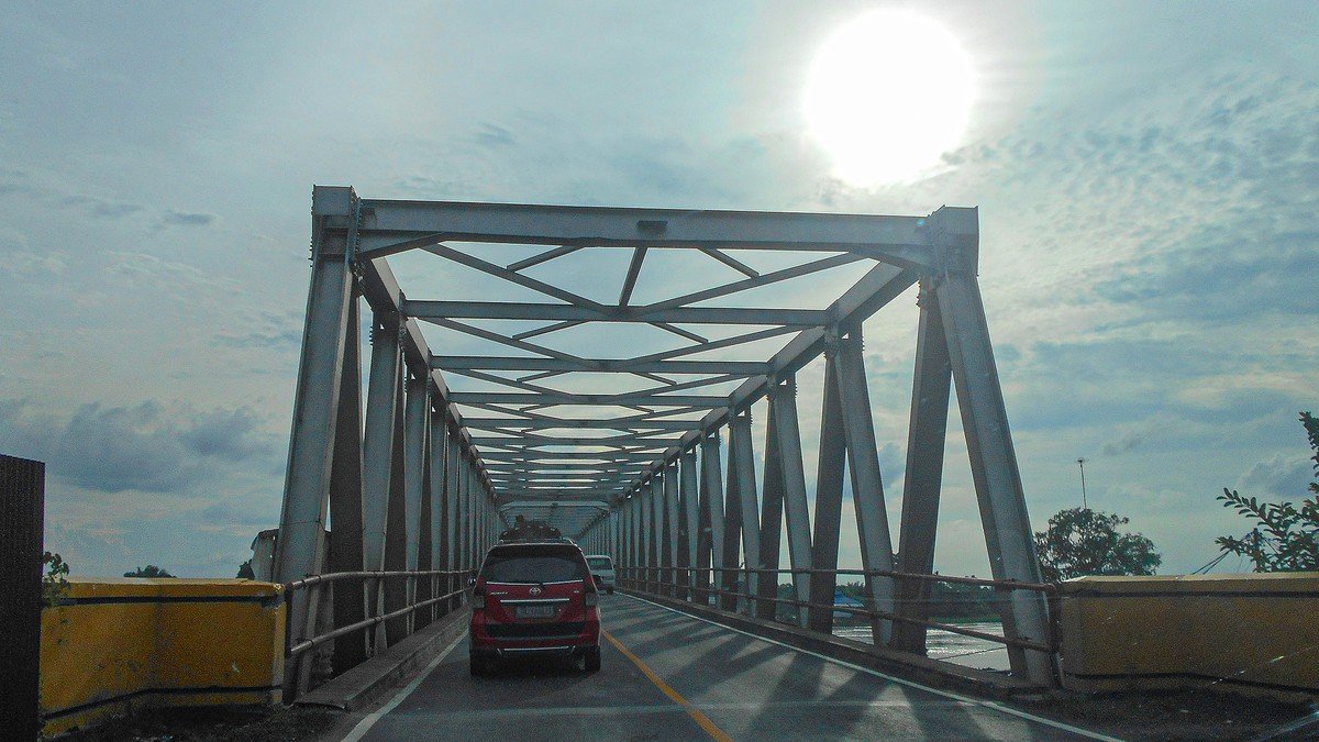 Modern multi-lane elevated highway toll road winding through tropical green landscapes in Indonesia
