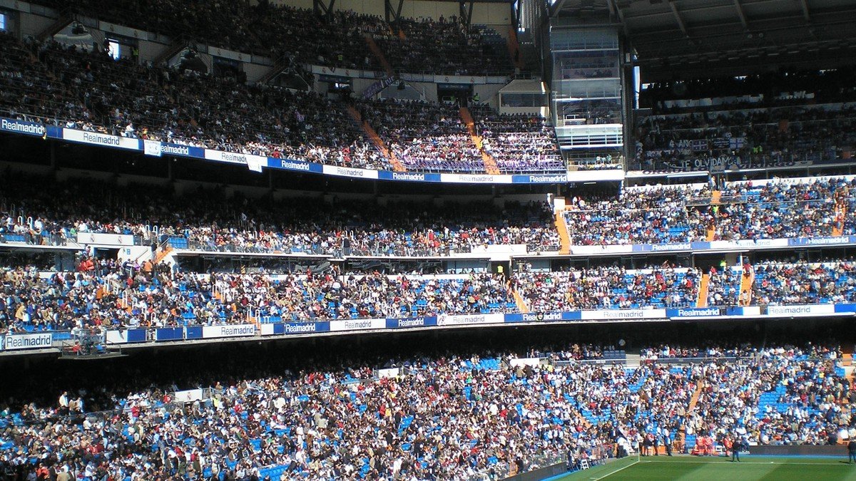 Kylian Mbappé celebrating a goal with Real Madrid teammates at the Santiago Bernabéu stadium