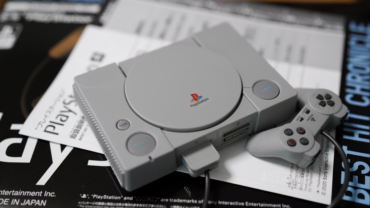 PlayStation gaming console and modern controller showcased on a minimalist display stand