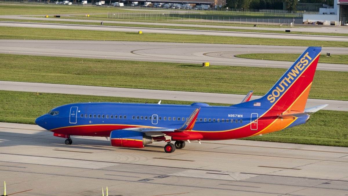 Southwest Airlines Boeing commercial passenger airliner parked at airport boarding gate