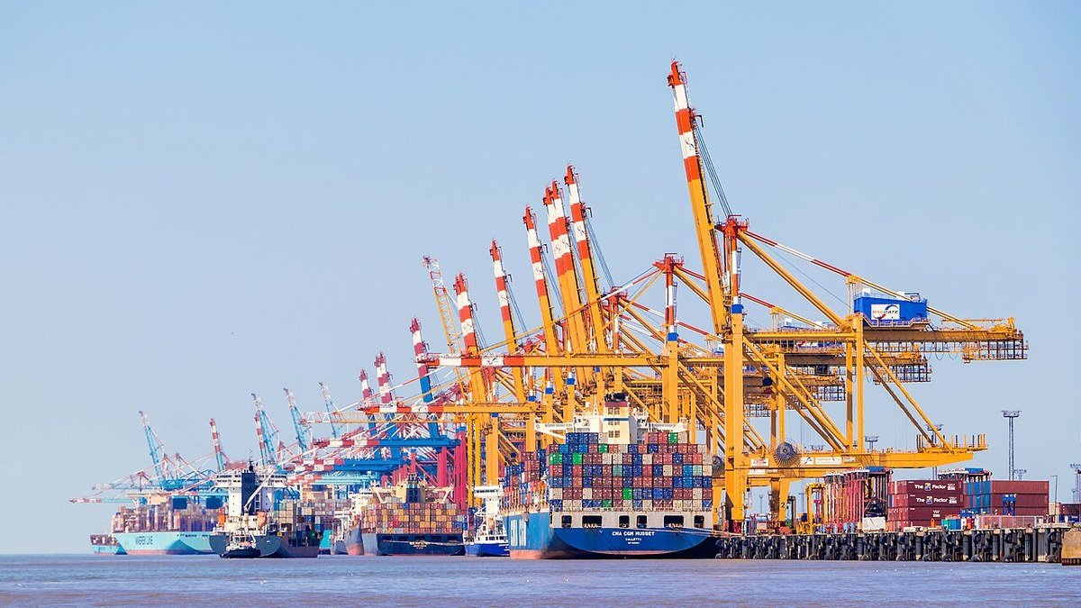 Container ships and gantry cranes operating at an East Coast commercial shipping terminal