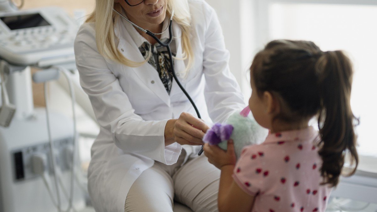 Doctor holding a stethoscope during a cardiac health consultation